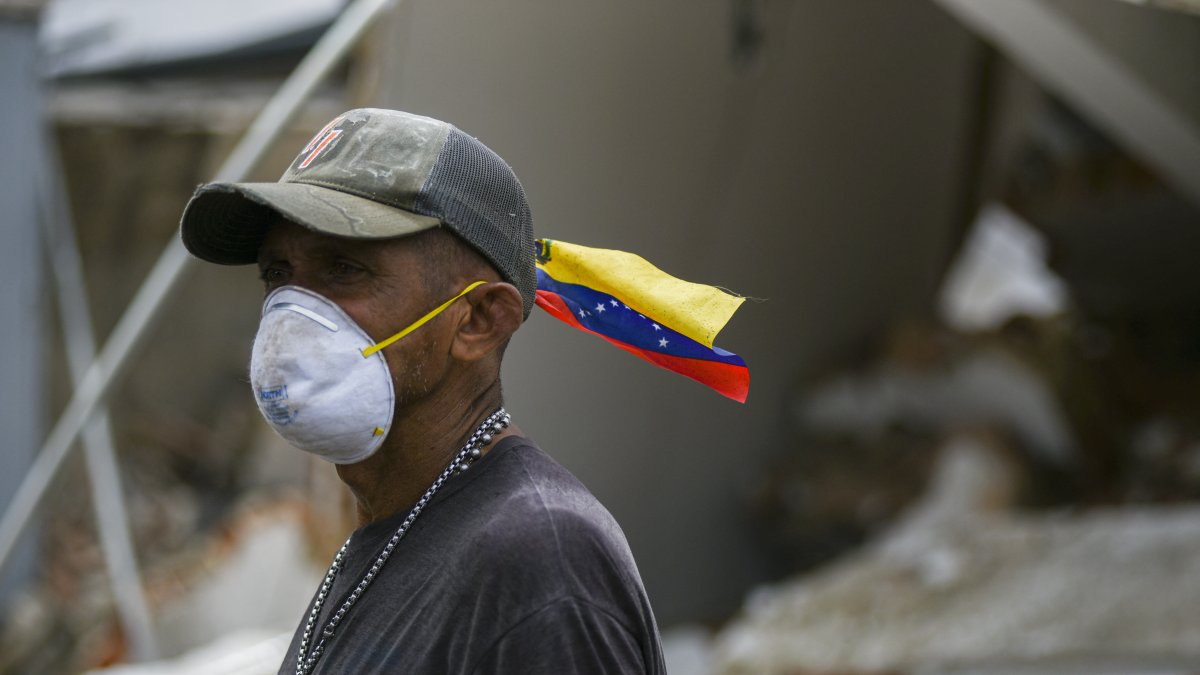 Volunteers and residents search for survivors amid the rubble of collapsed buildings in Caraballeda, La Guaira state, Venezuela.