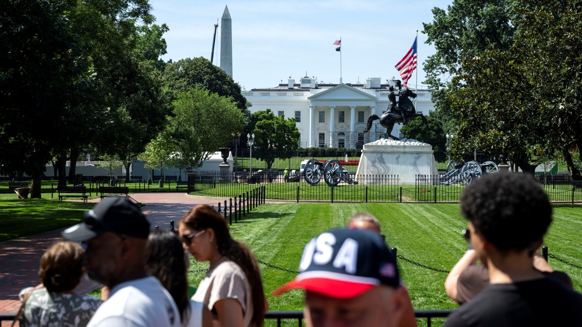People walk and take photos in Lafayette Square