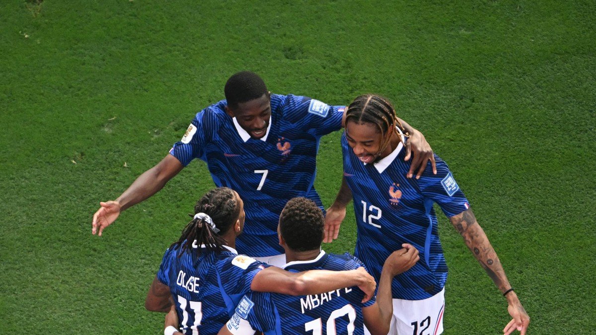 Kylian Mbappé, number 10, celebrates his team’s third goal alongside Dembélé, Barcola, and Olise