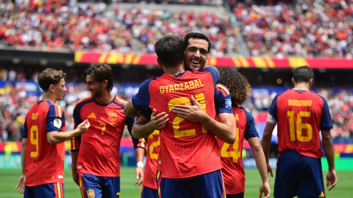Mikel Oyarzabal hugs Mikel Merino to celebrate his goal