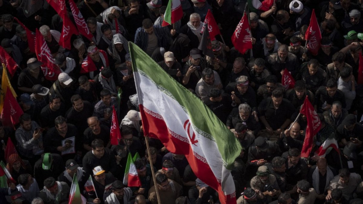 Pro-government supporters attend the funeral of Iran’s late supreme leader