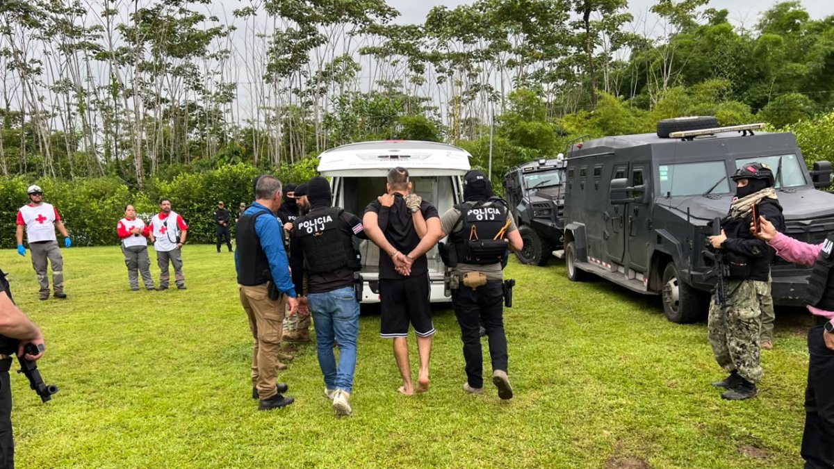 Agents escort alleged drug trafficker Alejandro Arias Monge