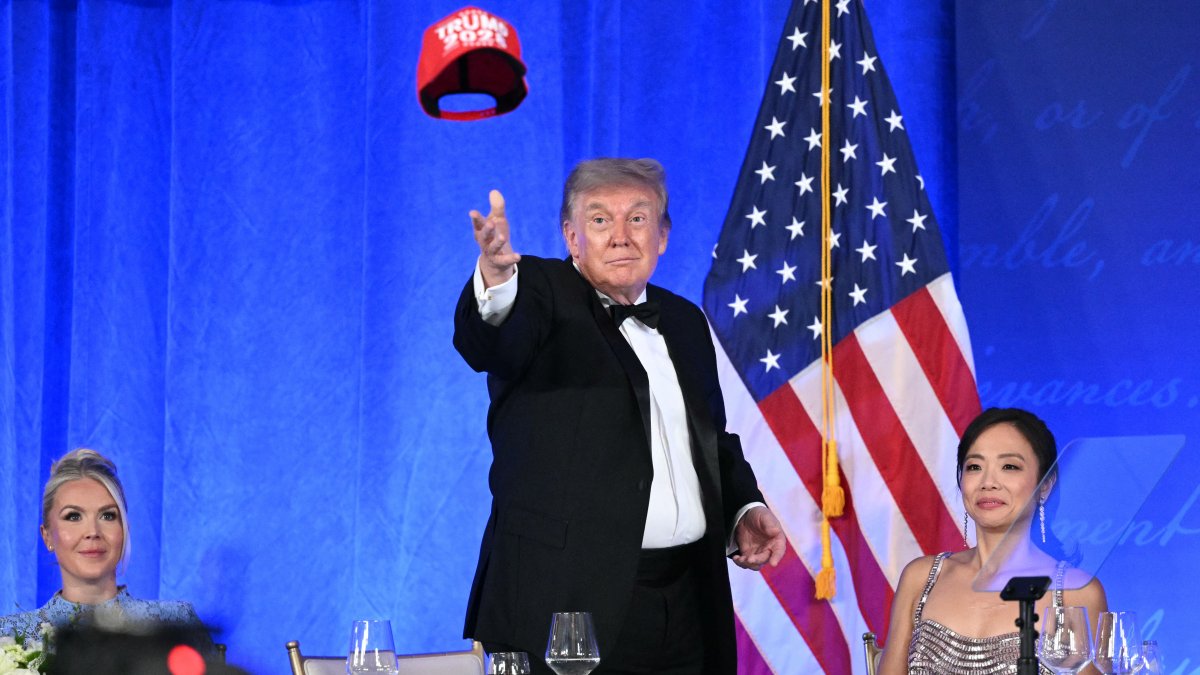US President Donald Trump throws his