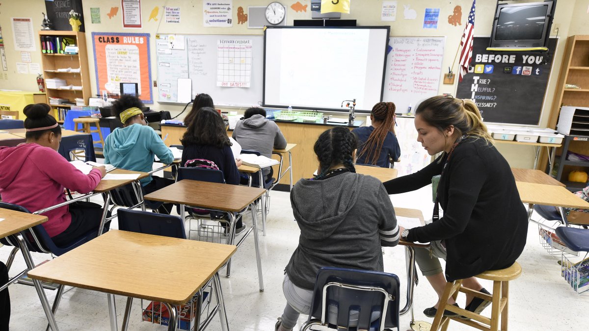 A teacher interacts with her students in a classroom (File photo)
