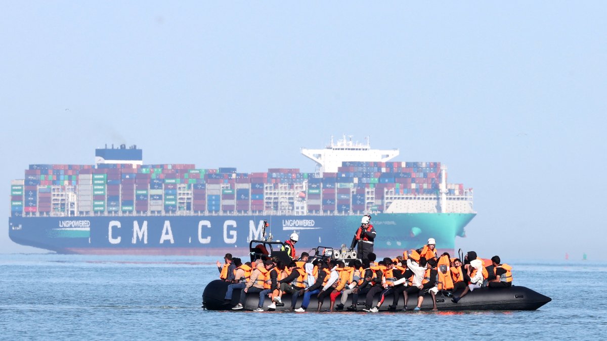 Migrants aboard a boat attempt to cross the English Channel - File photo