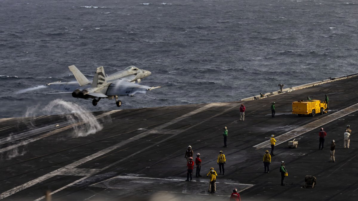 An F-18E Super Hornet taking off from the USS Abraham Lincoln.
