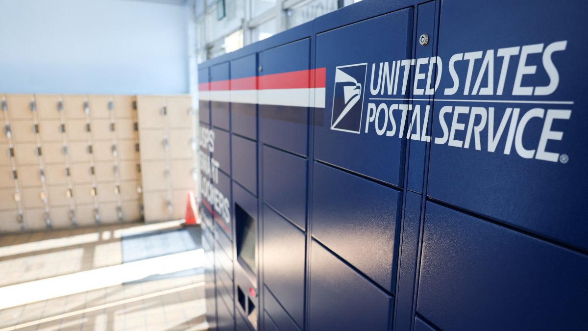 USPS Smart Lockers for package pickup stand in the lobby of the United States Postal Service (USPS)