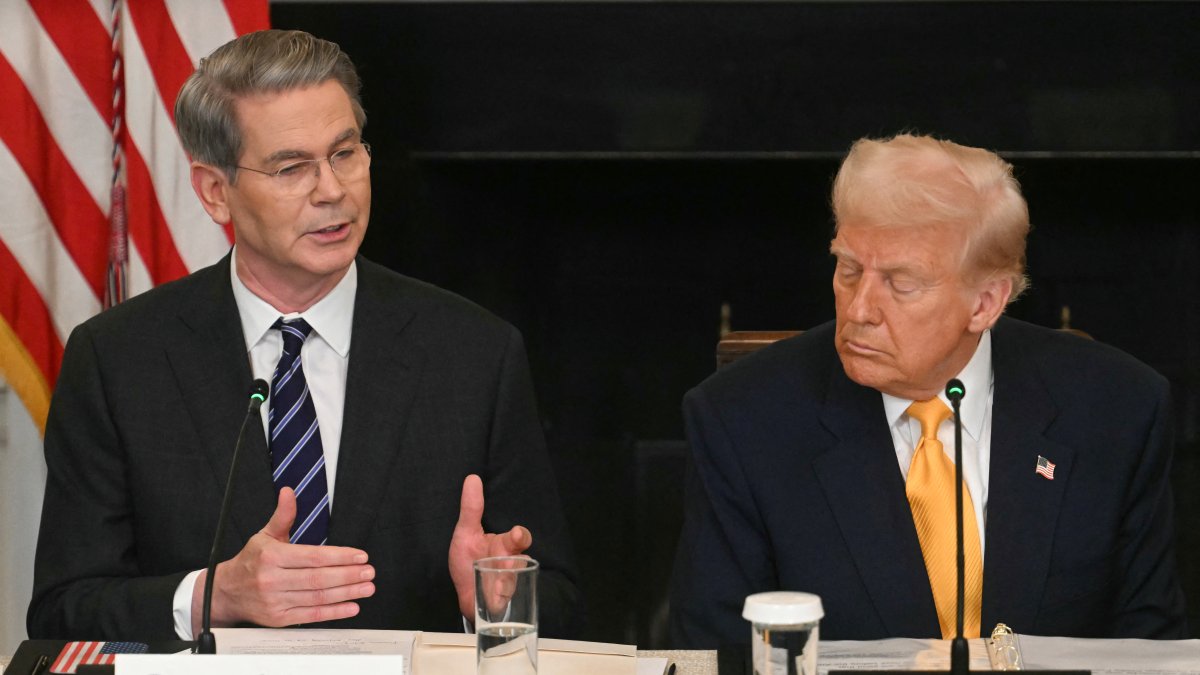 US President Donald Trump listen to US Secretary of Treasury Scott Bessent