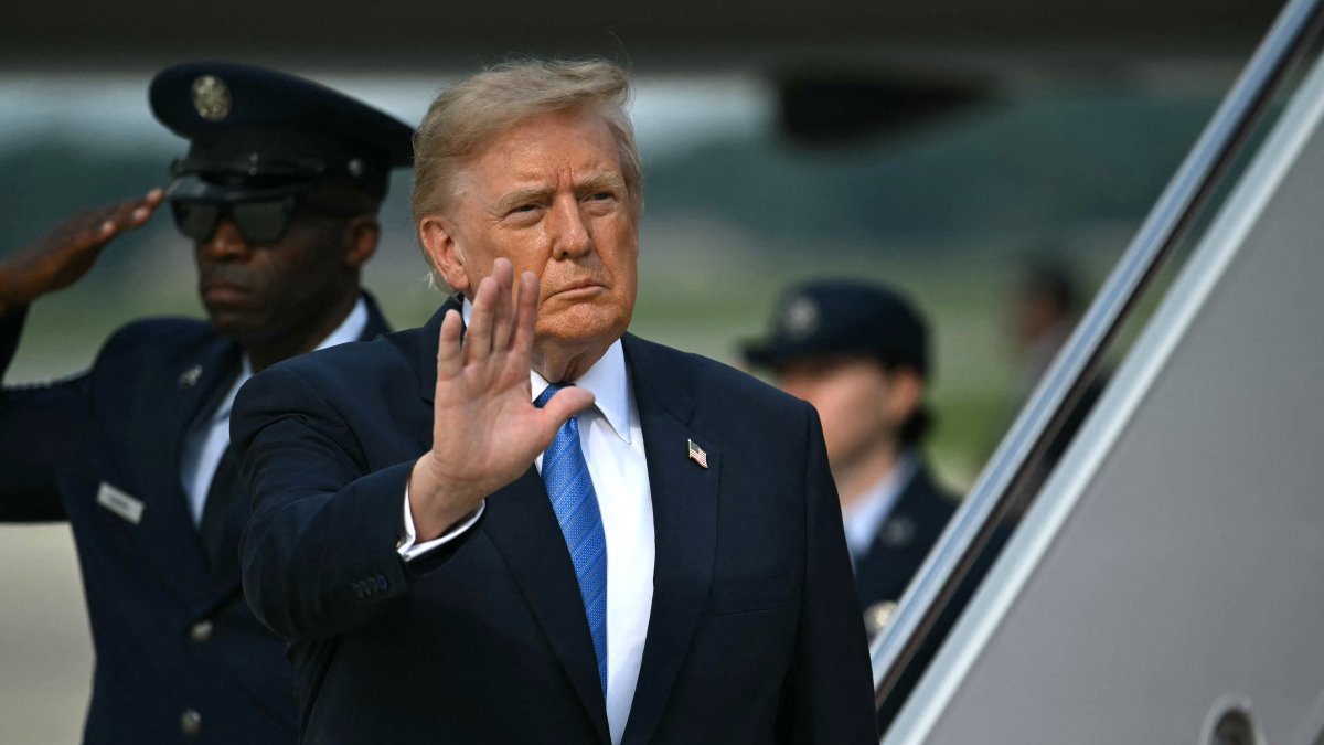 President Donald Trump waves as he steps off Air Force One at Joint Base Andrews, Maryland, on August 28, 2026.
