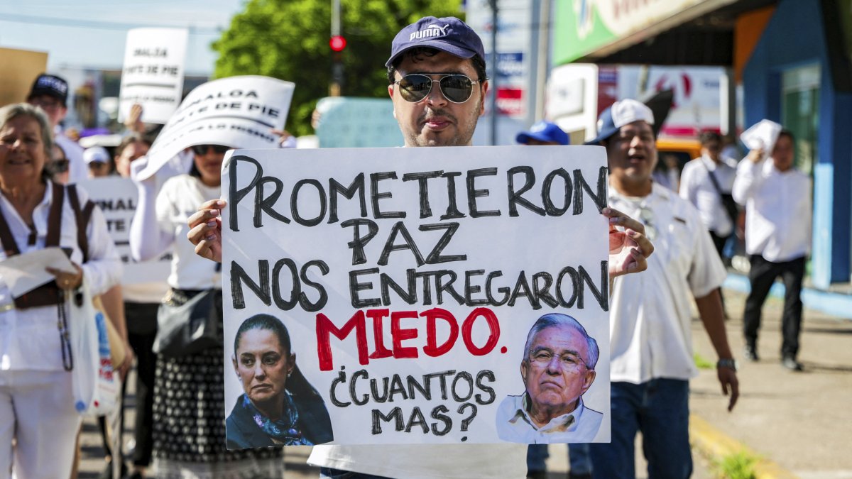 Un manifestante sostiene una pancarta