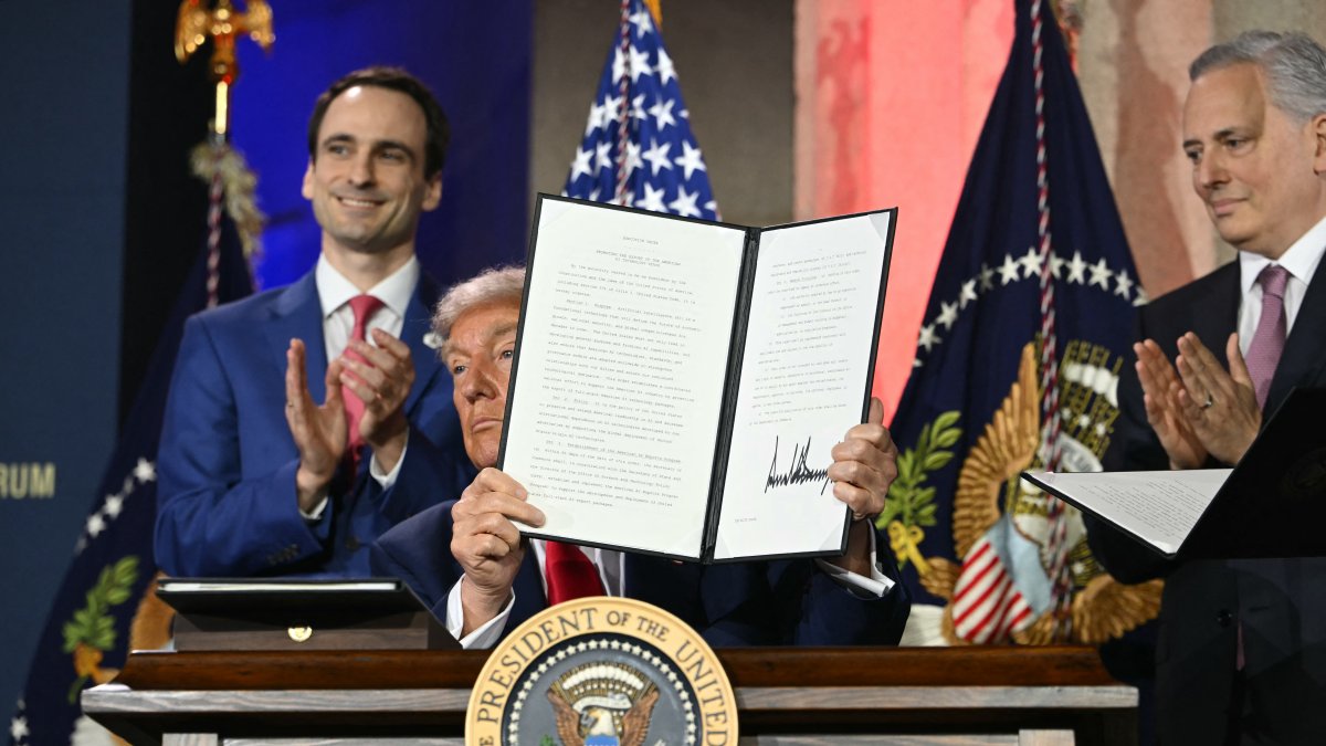 US President Donald Trump displays an executive order on artificial intelligence