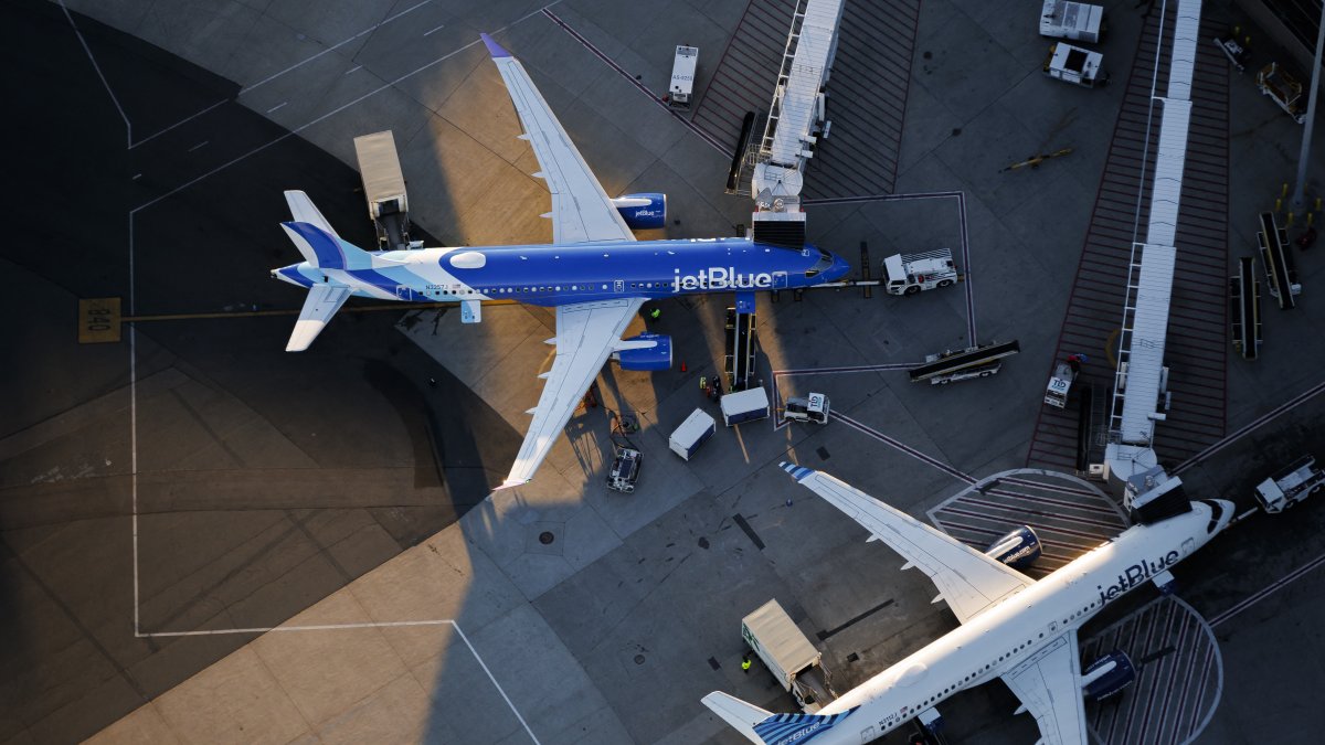 Two airplanes parked at Terminal C at Boston Logan International Airport