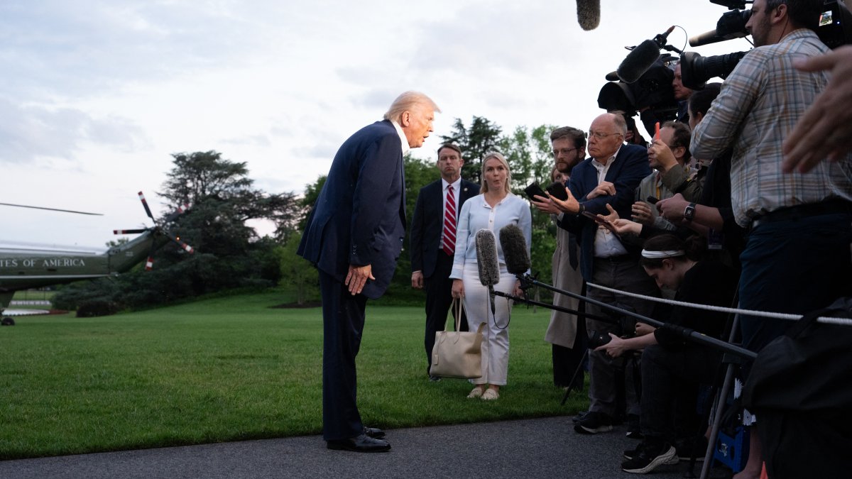 President Trump speaking with the media on the White House lawn.