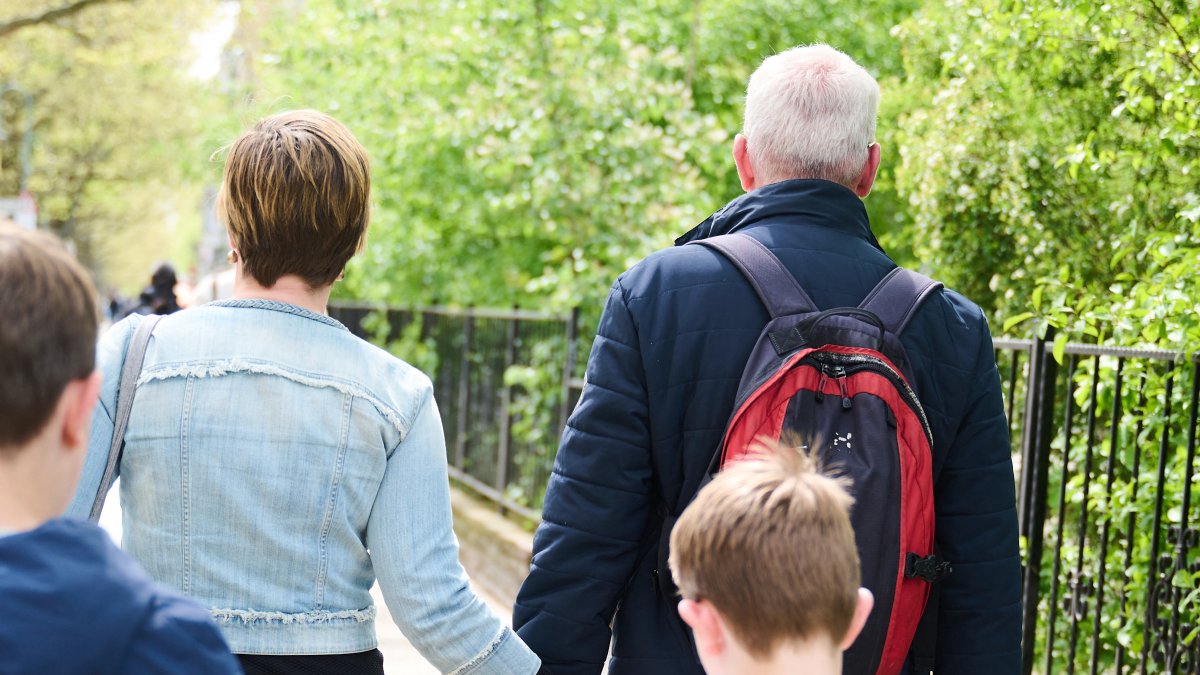 Parents take a walk with their two children. Illustration