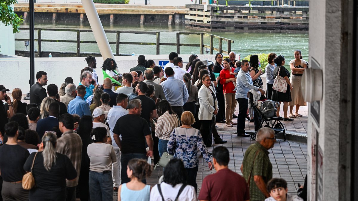 Several people wait in line outside the Miami Immigration Court in Miami, Florida, on September 3, 2026.