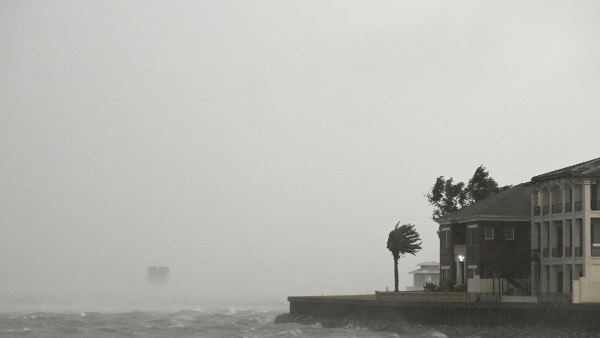 A house is battered by strong winds and storm surge from Hurricane Isaiah in Pensacola, Florida