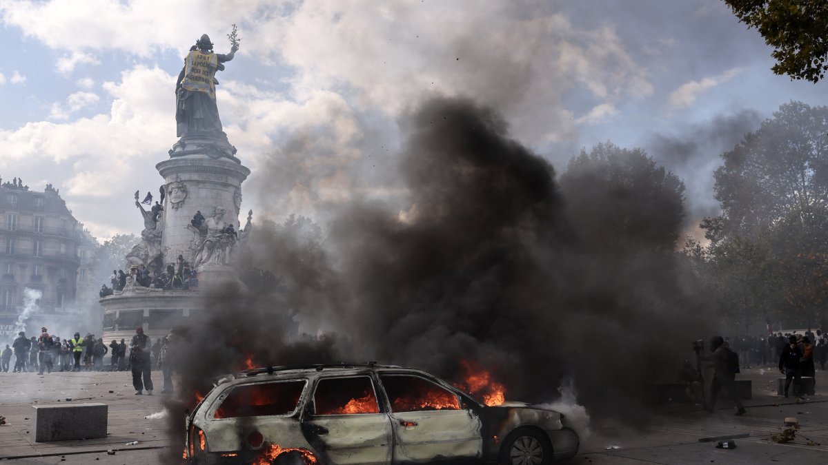 A vehicle on fire during a demonstration at Place de la République in Paris