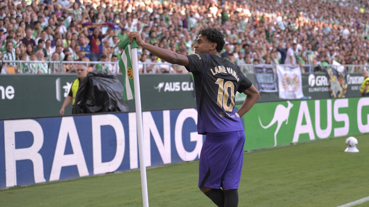Lamine Yamal celebrates his team's first goal during the Spanish league match between Real Betis and FC Barcelona.