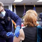 Una mujer recibe la vacuna contra el covid-19 mientras el presidente Joe Biden visita un centro de vacunación contra el covid-19 del Departamento de Asuntos de Veteranos (VA) en Washington D. C. el lunes 8 de marzo de 2021