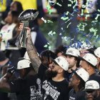 Seattle Seahawks' players celebrate with the Vince Lombardi Trophy after defeating the New England Patriots during Super Bowl LX at Levi's Stadium in Santa Clara, California on February 8, 2026. (Photo by Patrick T. Fallon / AFP)