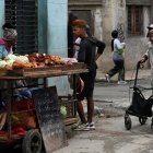 People buy food on a street in Havana