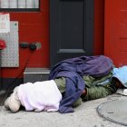 A homeless person sleeps near Madison Square Garden on April 29, 2020 in New York City. New York Citys homeless have sought refuge in the subways to escape the coronavirus pandemic, causing subway workers to ask the city for a solution. New York's new plan calls for police officers and social workers going into stations late night and removing homeless people from the trains and offering them shelter. Subway workers then clean and disinfect cars. (Photo by Angela Weiss / AFP)
