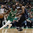 Apr 23, 2025; Boston, Massachusetts, USA; Boston Celtics guard Jaylen Brown (7) drives past Orlando Magic center Wendell Carter Jr. (34) during the second half of game two of the first round of the 2024 NBA Playoffs at TD Garden