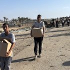 Palestinians carry humanitarian aid in Gaza