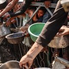 Palestinians crowd at a lentil soup distribution point in Gaza City in the northern Gaza Strip on July 27, 2025. (Photo by Omar AL-QATTAA / AFP)