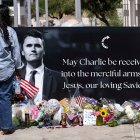 People gather outside the headquarters of Turning Point USA to mourn the loss of Charlie Kirk