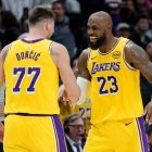 Los Angeles Lakers forward/guard Luka Dončić (77) celebrates a three point basket with forward LeBron James (23) against the New Orleans Pelicans during the second half of an NBA basketball game in New Orleans, Tuesday, Jan. 6, 2026. (AP Photo/Matthew Hinton)
