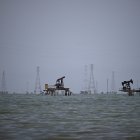 Oil rigs are pictured in Lake Maracaibo, Zulia State, Venezuela on July 12, 2024. A putrid smell hangs over the black-stained shores of Lake Maracaibo in Venezuela, where an oil slick is emblematic of the steep decline in the country's once-enviable petroleum industry. Here, much like elsewhere in what was once Latin America's richest country, economic hardship drives much of the discussion ahead of the July 28 elections, in which President Nicolas Maduro will seek a third six-year term. (Photo by Federico PARRA / AFP)