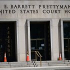 Members of the media and protesters calling for the impeachment of President Donald Trump gather at the E. Barrett Prettyman United States Court House in Washington, DC, United States, on April 27, 2026. This gathering takes place in advance of the arraignment of 31-year-old Cole Allen, who is accused of opening fire at the White House Correspondents' Association dinner over the weekend. Local and federal law enforcement are positioned outside the courthouse prior to Allen's appearance. (Photo by Kyle Mazza/NurPhoto) (Photo by Kyle Mazza / NurPhoto via AFP)