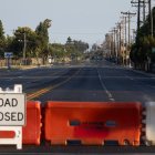 Roads remain closed after residents were evacuated following a chemical leak from a large storage tank that threatened nearby homes in Garden Grove, California, on May 24, 2026. Authorities in California on May 24 said they discovered a crack in a damaged tank of toxic chemicals, potentially relieving pressure as the threat of an explosion has forced tens of thousands of residents to evacuate. About 50,000 residents were ordered to leave their homes in the Garden Grove area of Orange County, southeast of Los Angeles, on Friday after the tank began to leak, sending fumes over a heavily populated area about five miles from Disneyland. (Photo by Blake Fagan / AFP)