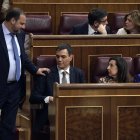 Socialist MP's Jose Luis Abalos Pedro Sanchez (L) greets the leader of Spanish Socialist Party PSOE, Pedro Sanchez during a no-confidence motion tabled by Spanish Socialist party at the Lower House of the Spanish Parliament in Madrid on May 31, 2018. Spanish Prime Minister Mariano Rajoy faces a no-confidence vote at the end of the week after a court ruled his governing Popular Party benefited for years from a large kickbacks-for-contracts scheme. (Photo by OSCAR DEL POZO / AFP)