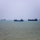 In this picture obtained from Iran's ISNA news agency on June 18, 2026, vessels are seen anchored in Bandar Abbas along the Strait of Hormuz. Oil prices tumbled after Trump and his Iranian counterpart separately signed their accord to end the Middle East war, with the Strait of Hormuz to reopen but two months of negotiations lying ahead. (Photo by AMIRHOSSEIN KHORGOOEI / ISNA / AFP) /