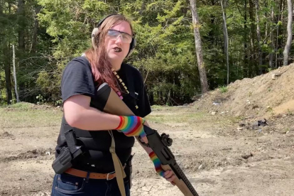 Still from a Queer Armorer video, showing Rainbow Reload member Fin Smith handling a shotgun at a shooting range.