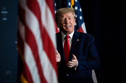 President Donald Trump on stage in Tampa applauding in July 2022.